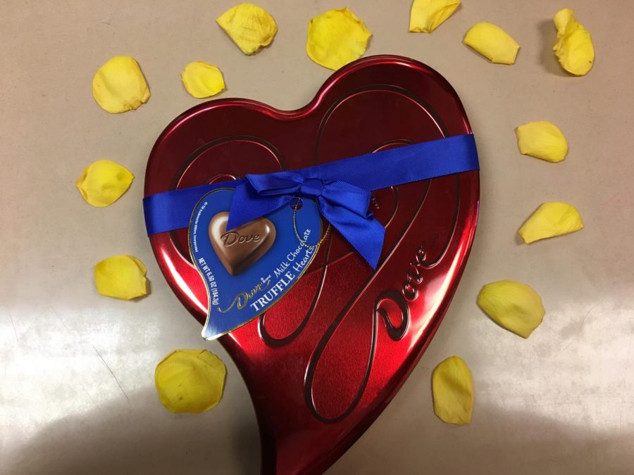 Chocolate container covered with yellow rose pedals.