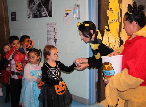 Preschool students collecting candy around the school. 