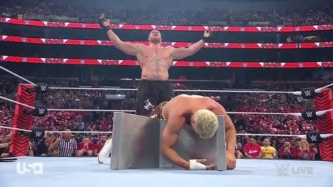 Brock Lesnar stands over a injured Cody Rhodes after brutal attack on Monday Night Raw. 