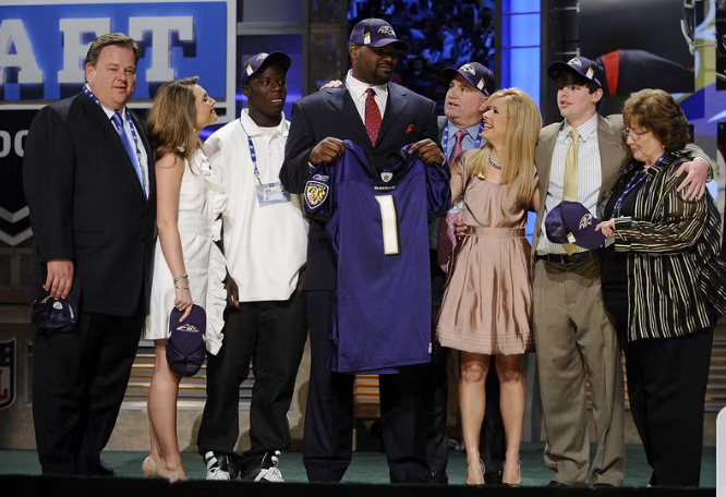 The photo shows Tuohys and Oher at the NFL draft in 2009. 