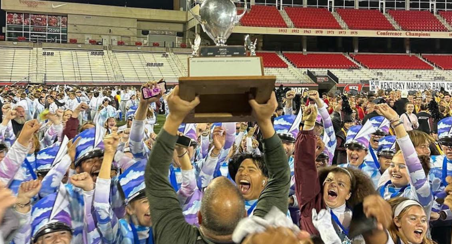 A photo of the Bourbon County Marching Band celebrating after winning State.