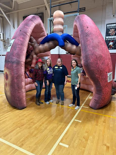 in the picture stands Lisa Doyle, BCMS YSC, Tonya Pauley,  Regional Cancer Control Specialist II, Samantha Payne, New Vista Prevention Specialist and Ann Marie Gonzales,  Bourbon County Health Department Health Educator III all inside of the giant inflatable lung. 
