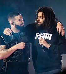 Rap music stars, Drake and J. Cole, photographed performing together at a concert. 