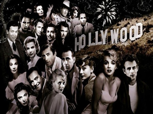 A photo of all the old Hollywood actors with the infamous, Hollywood sign. 