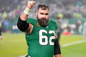 Jason Kelce signals to fans in the stands while wearing the teams fan favorite Kelly Green jerseys. 