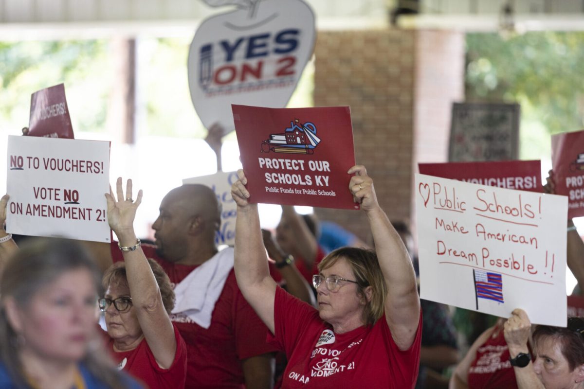 Democrat and Republican supporters hold signs regarding Amendment 2 on Saturday, Aug. 3, 2024, during St. Jerome Picnic in Fancy Farm, Ky. (Austin Anthony for the Kentucky Lantern)