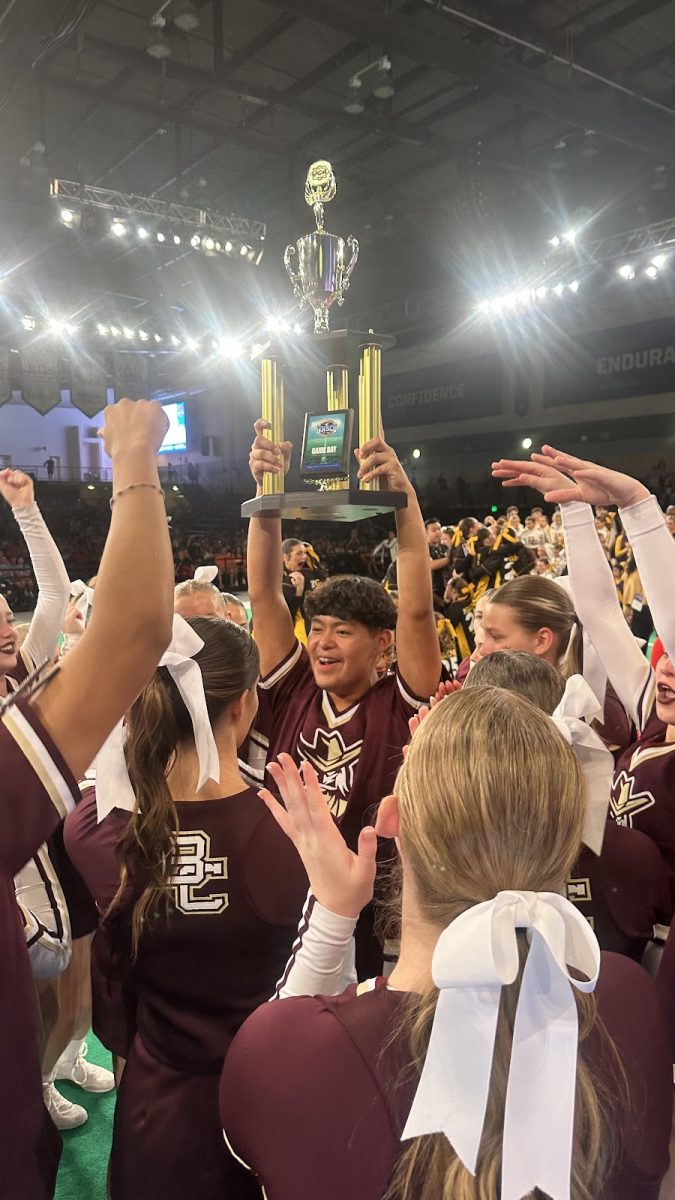 The cheerleaders getting their trophy. 