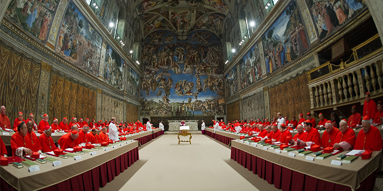 Cardinals from around the world praying in the Sistine Chapel at the Vatican